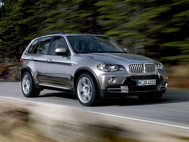 silver bmw suv in motion