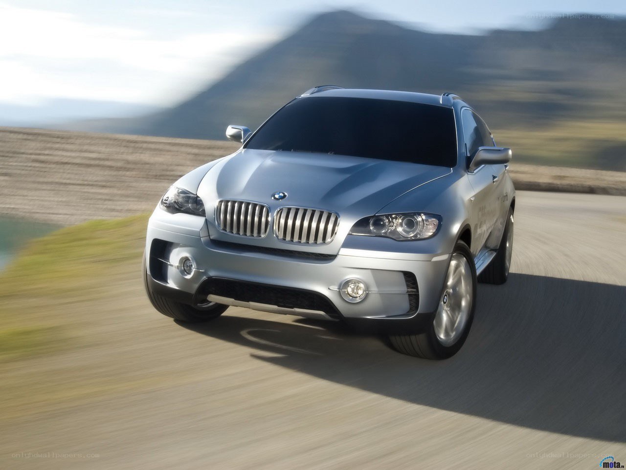 Silver BMW SUV on a road