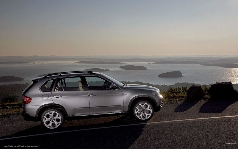Silver BMW SUV on coastal road