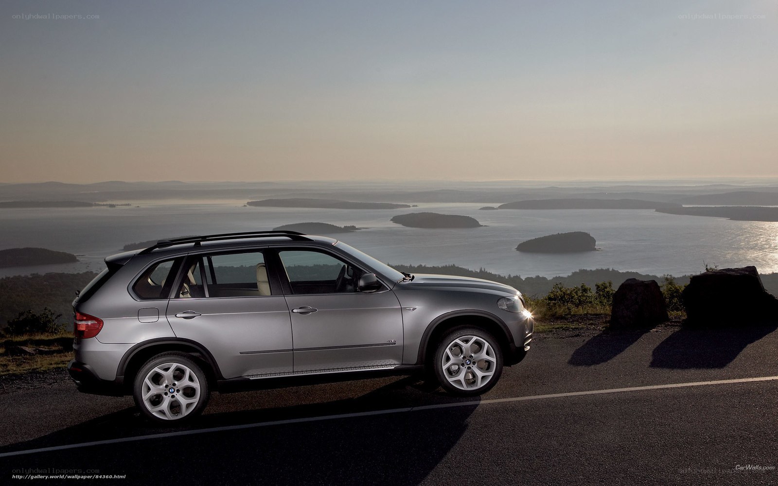 Silver BMW SUV on coastal road