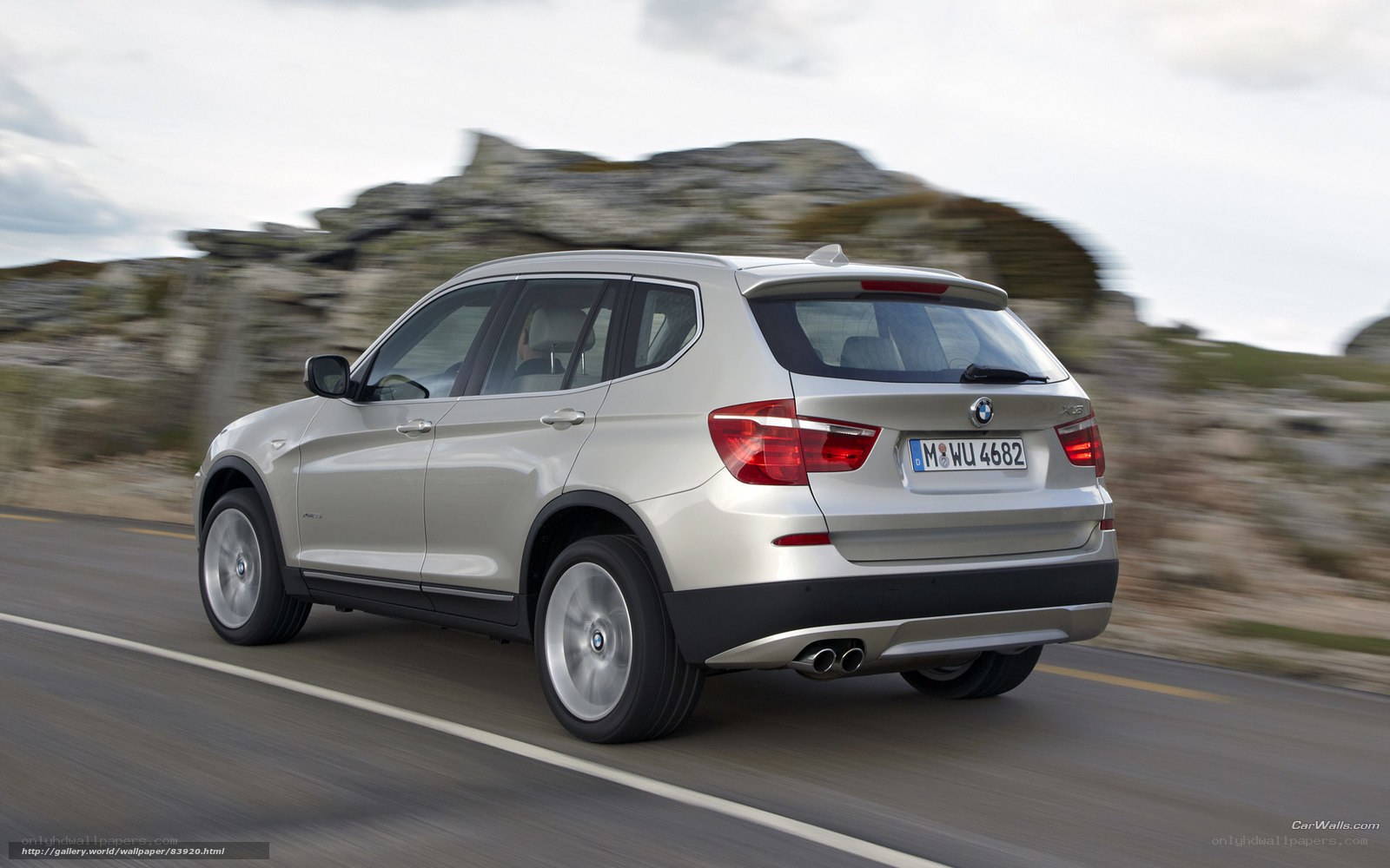 silver bmw x3 driving on road