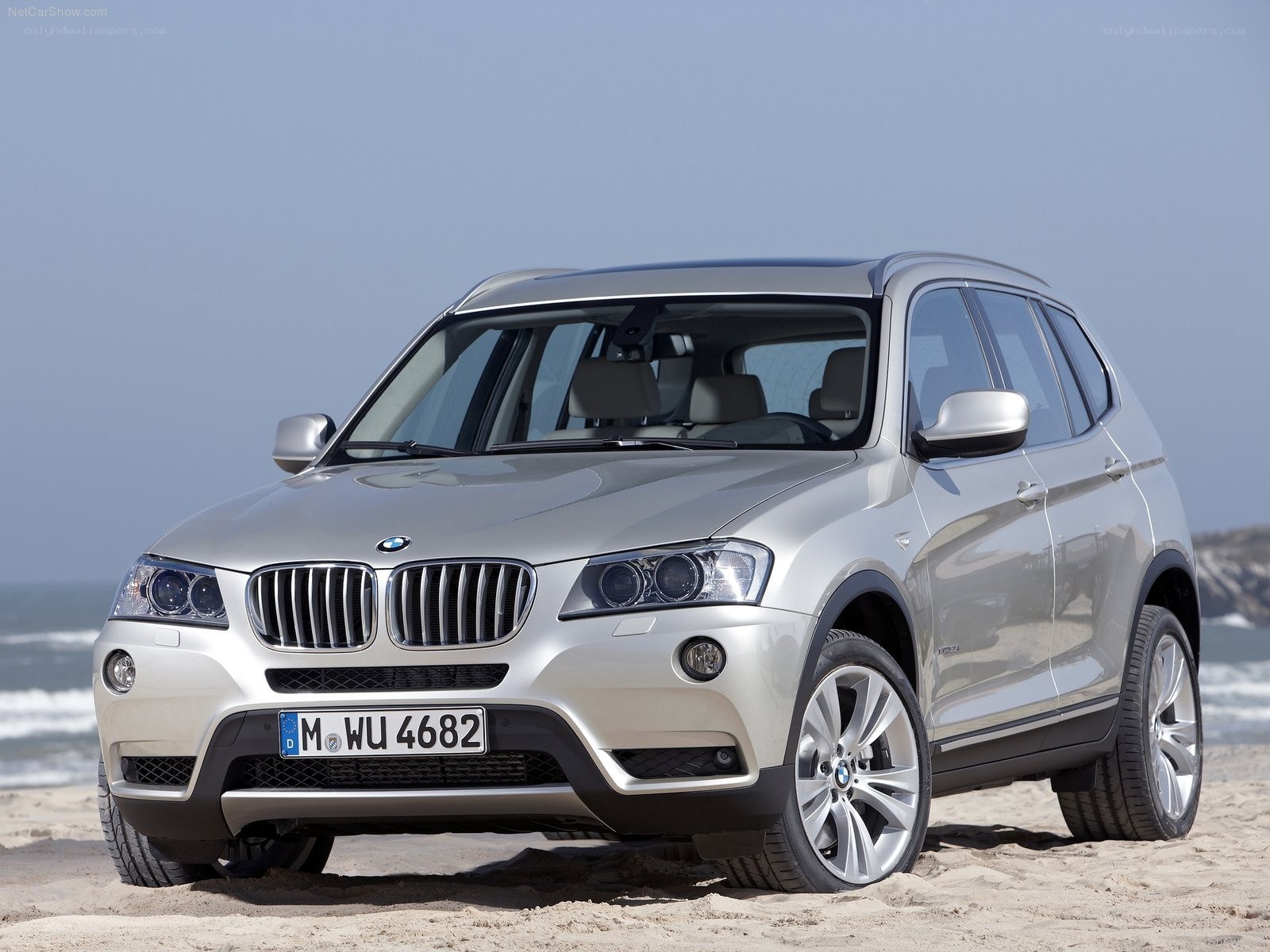 silver bmw x3 on beach