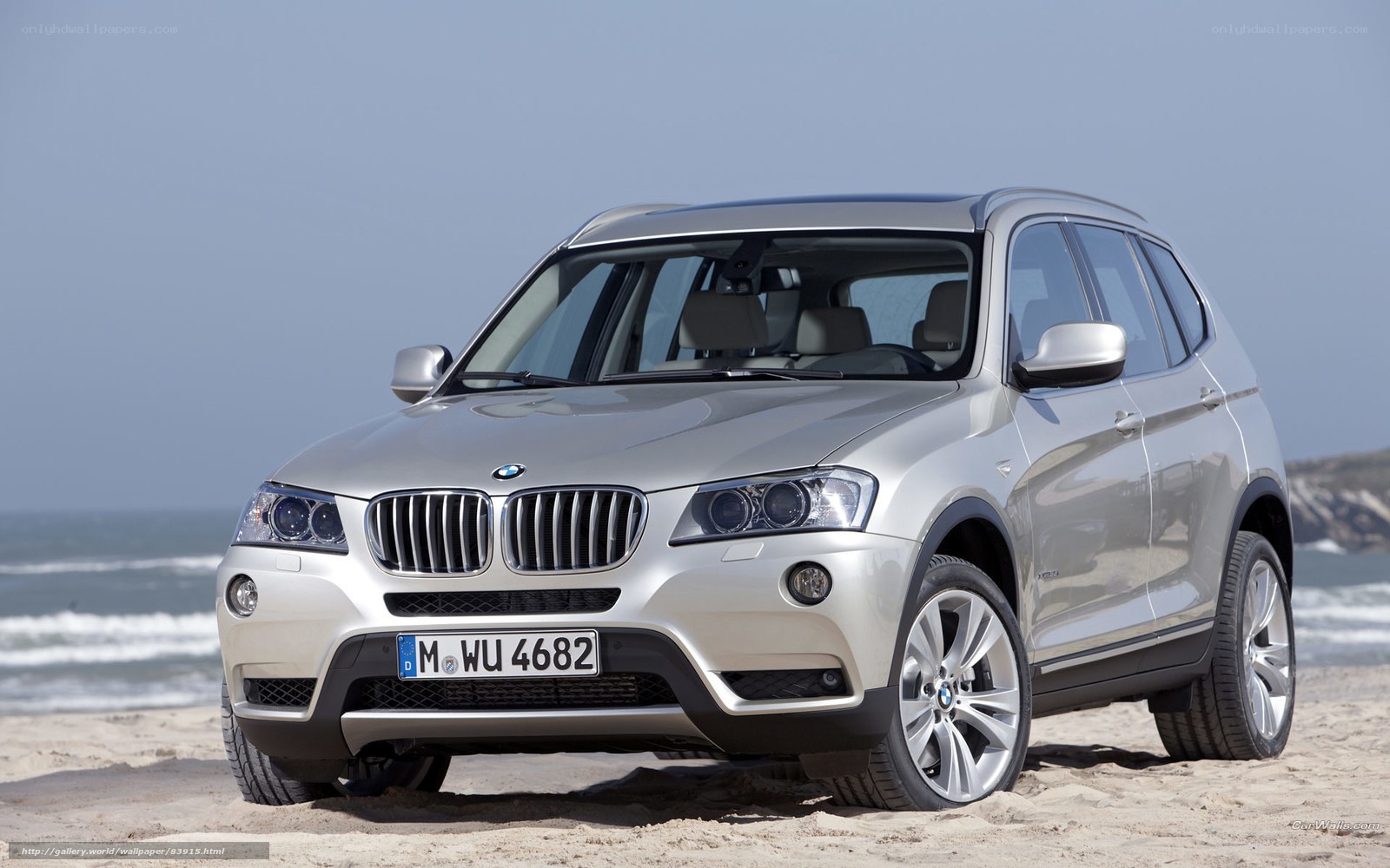 Silver BMW X3 on beach