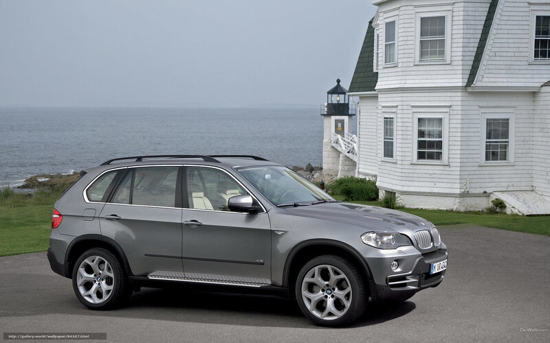 Silver BMW X5 by the coast