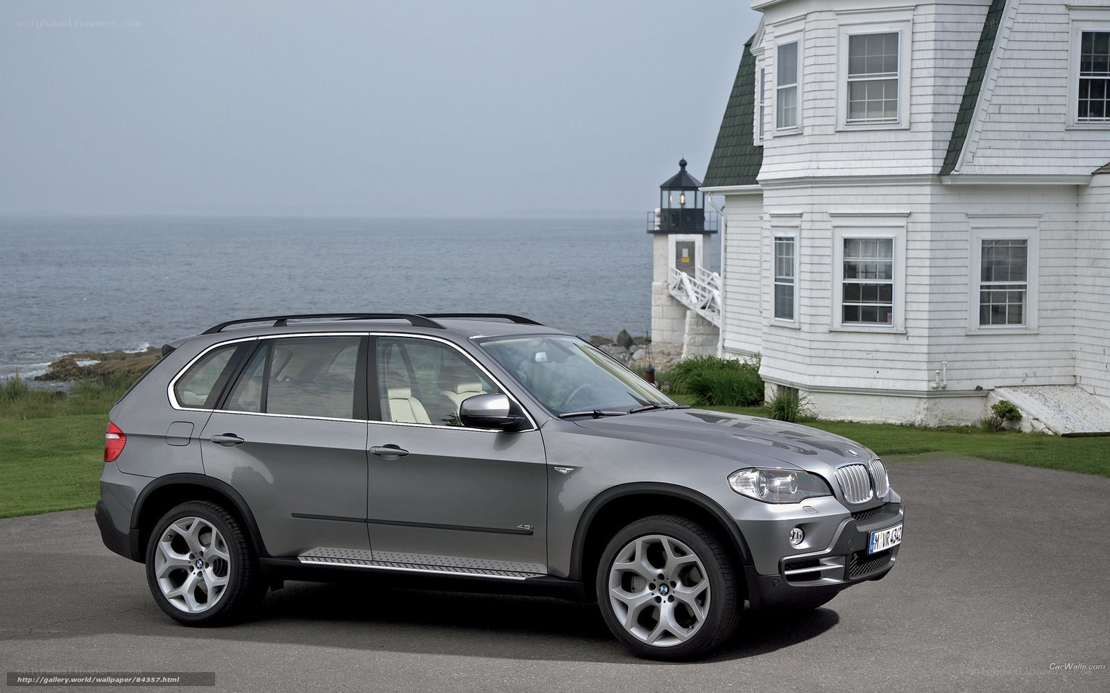 Silver BMW X5 by the coast