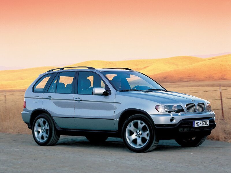 Silver BMW X5 on a desert road