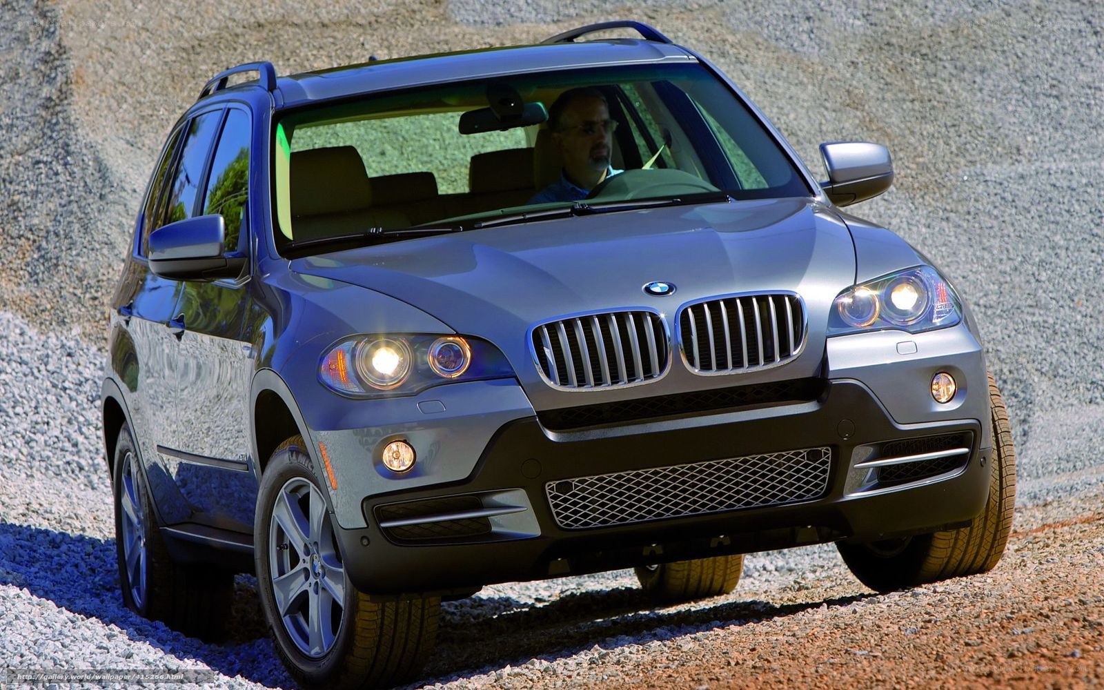 Silver BMW X5 on gravel