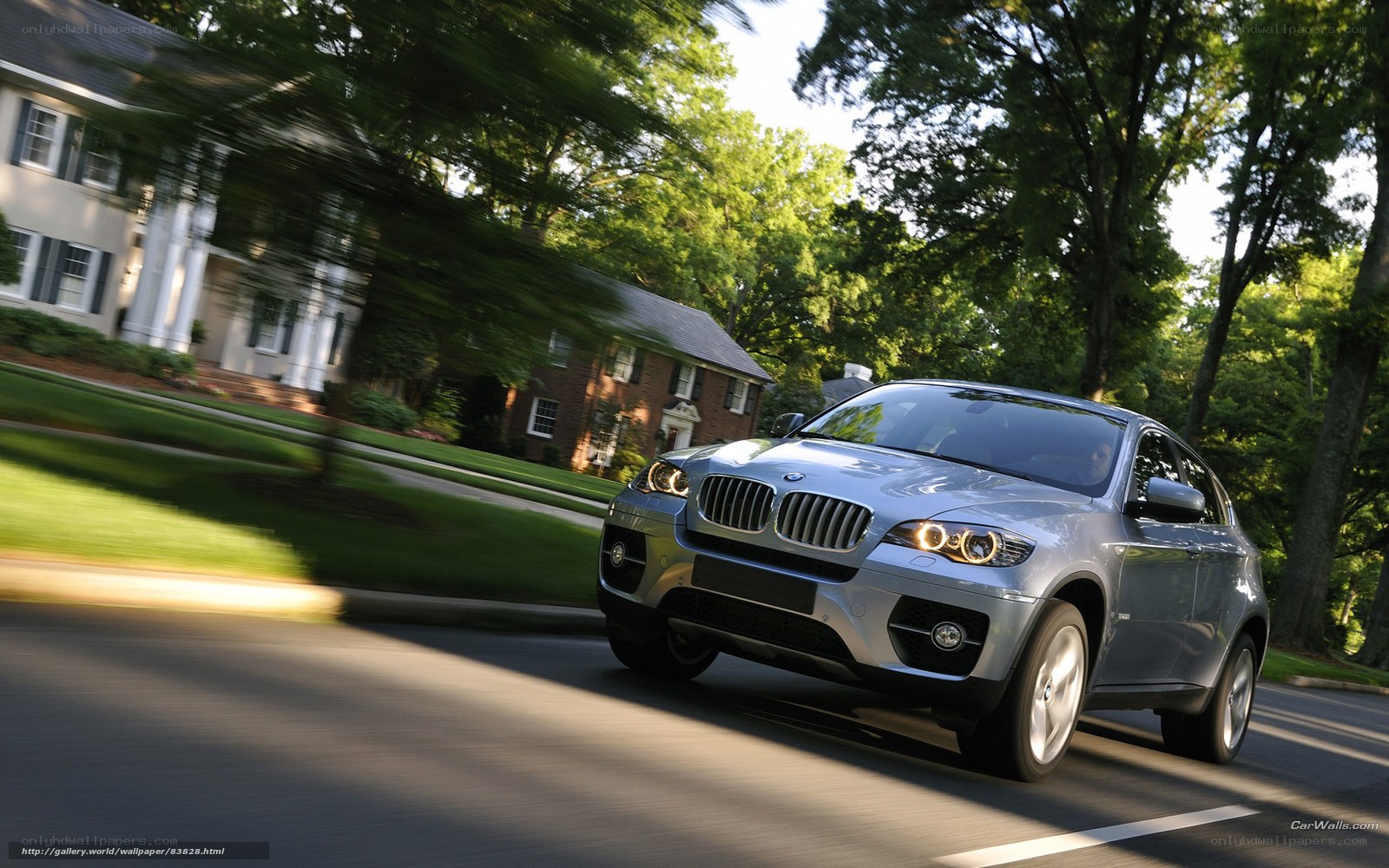 silver bmw x6 driving on street