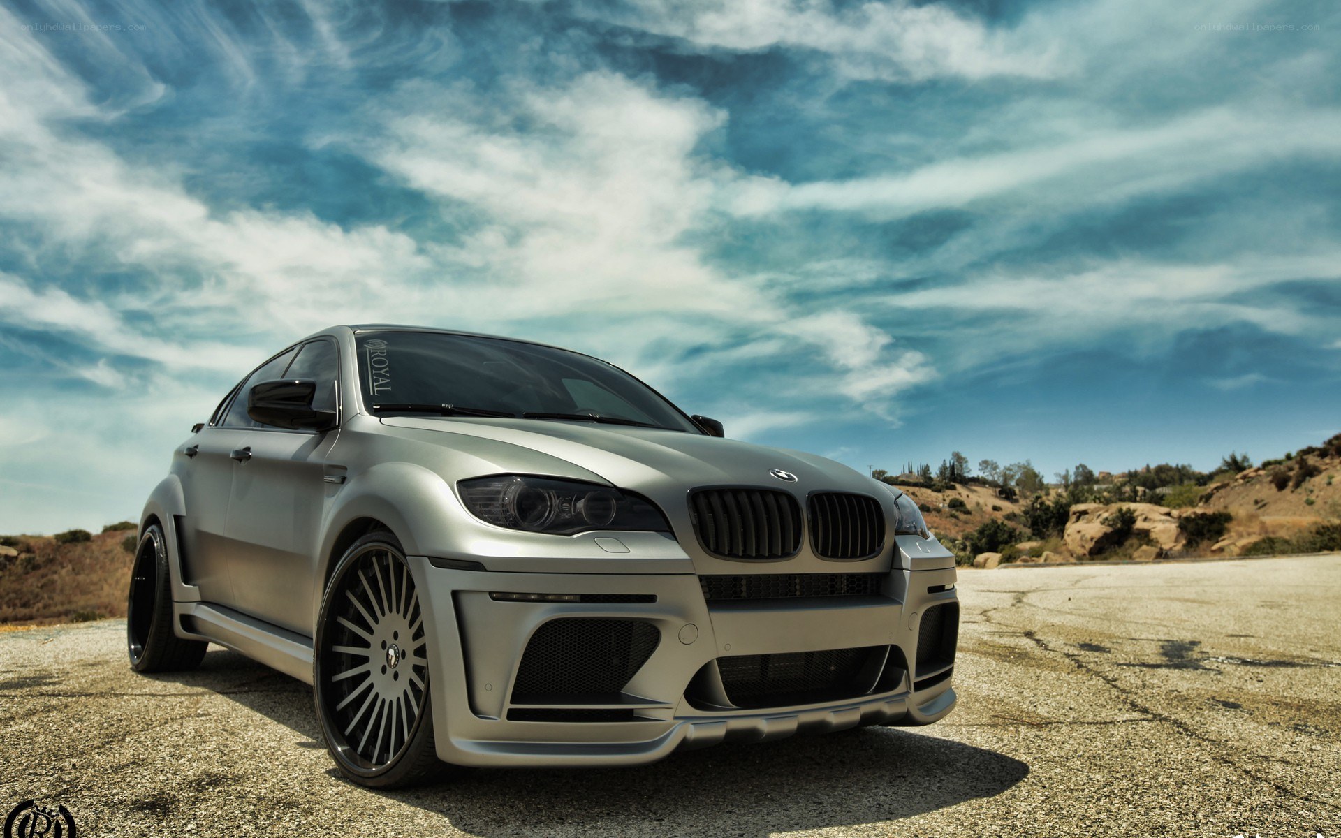 silver bmw x6 on asphalt