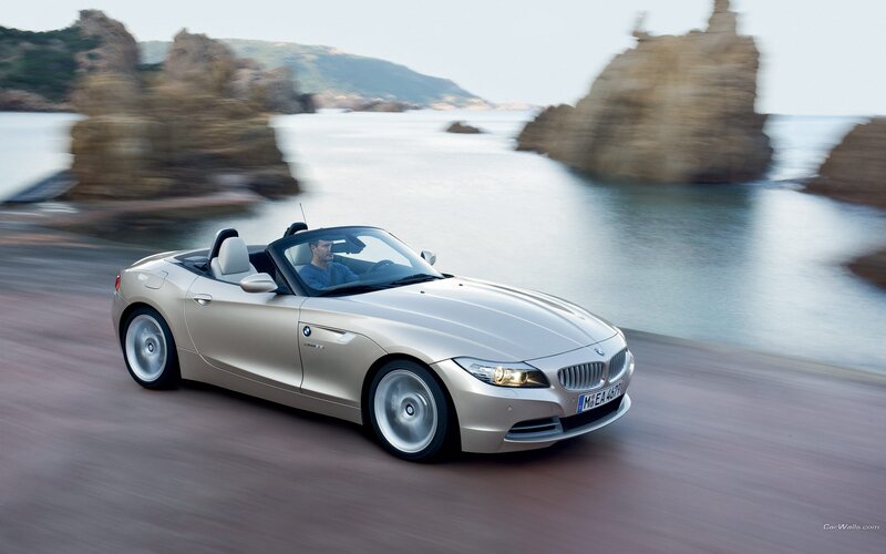 Silver BMW Z4 convertible on coastal road