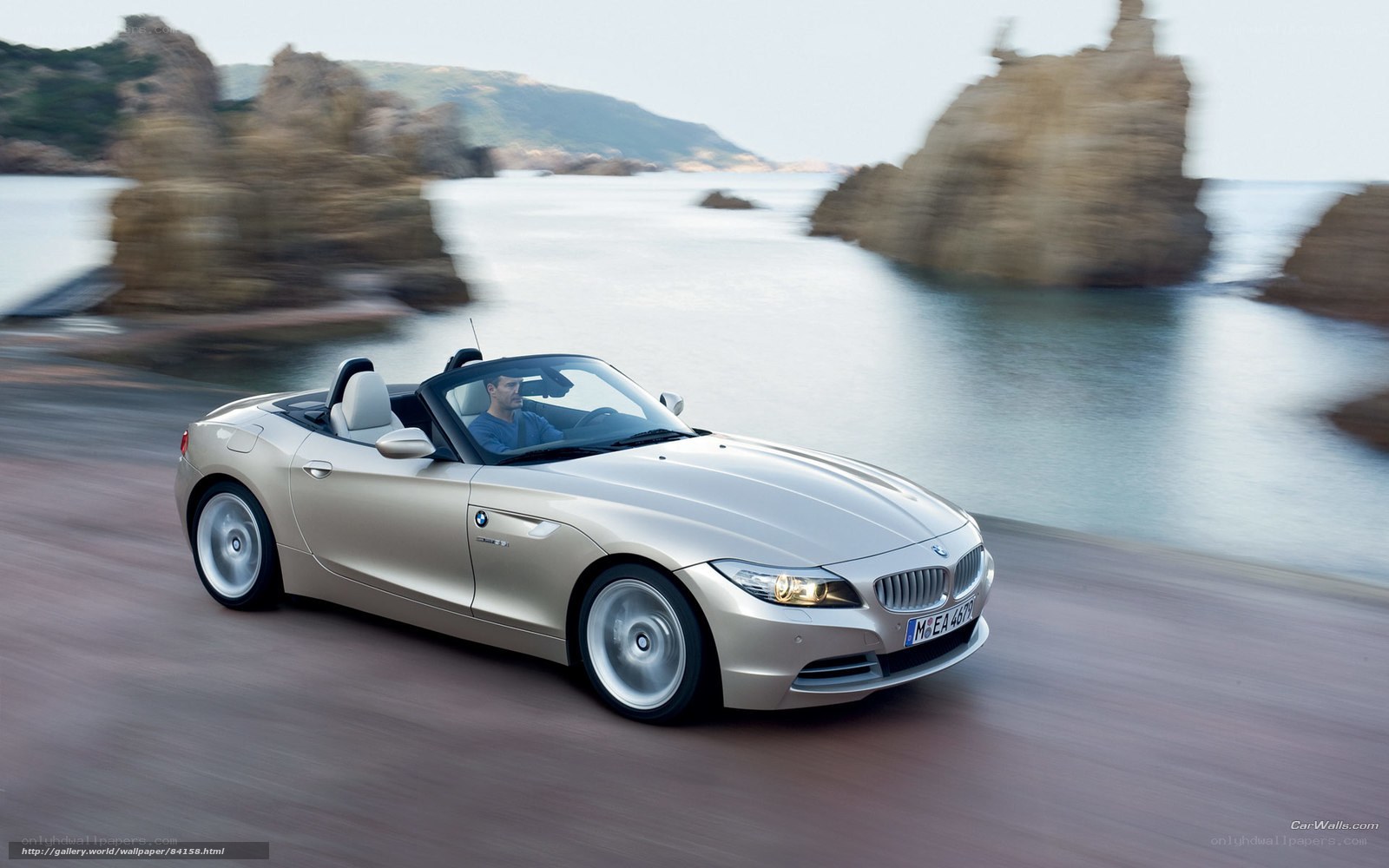 Silver BMW Z4 driving on coast