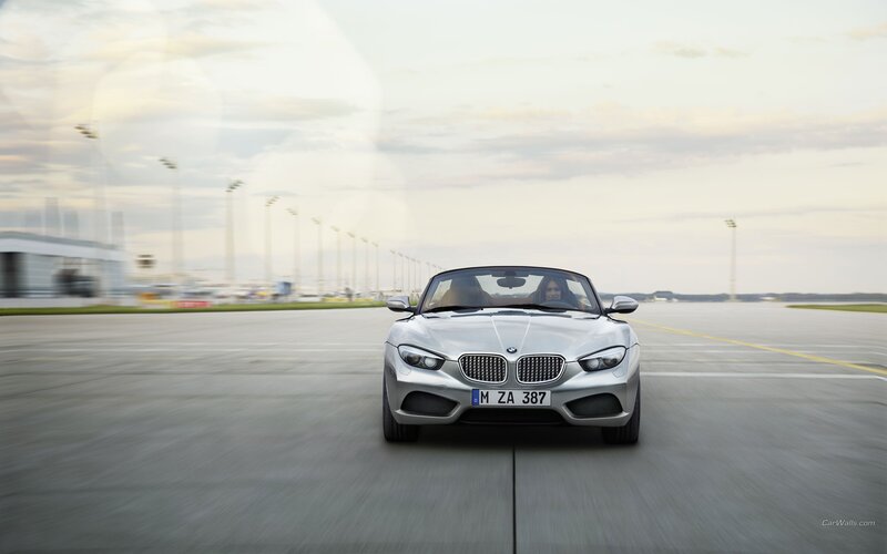 silver bmw z4 driving on tarmac