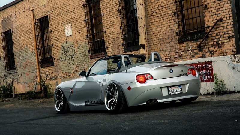 silver bmw z4 parked in alley