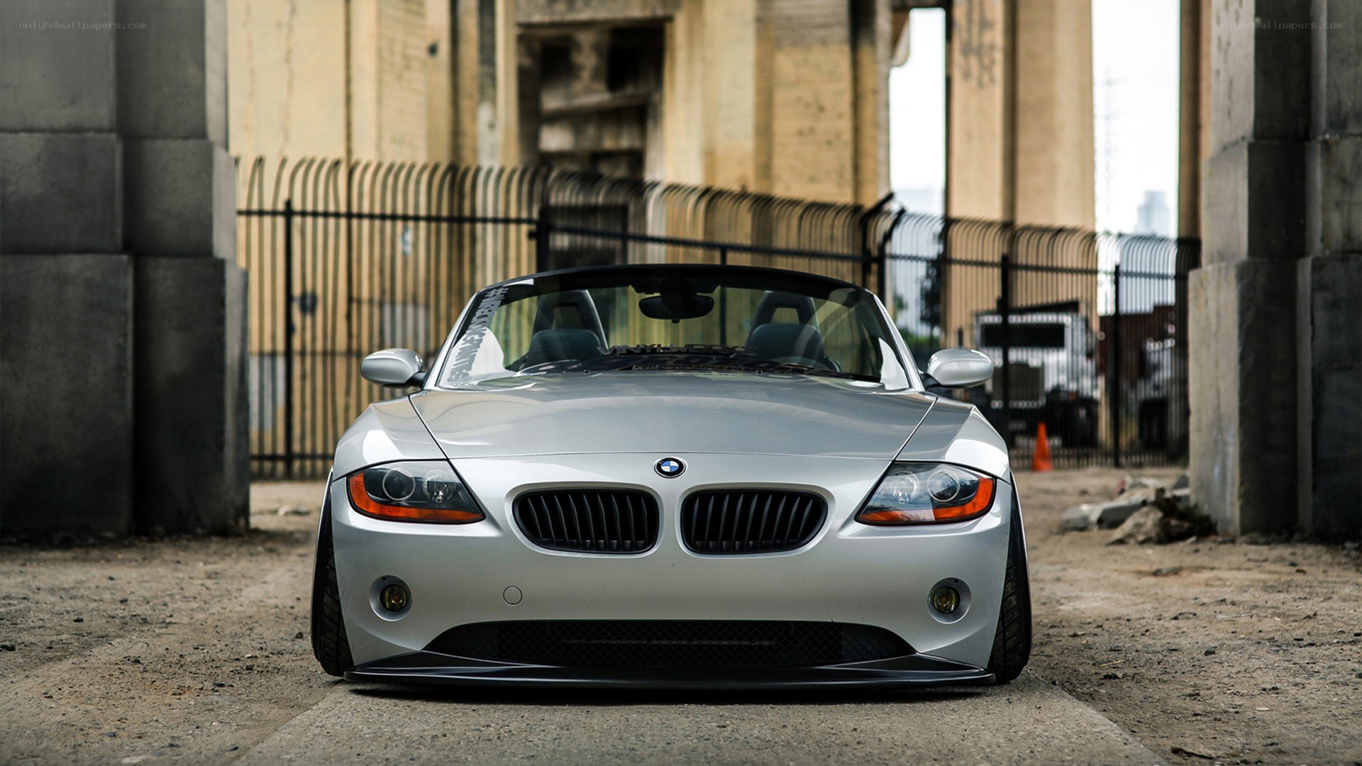 silver bmw z4 parked under bridge