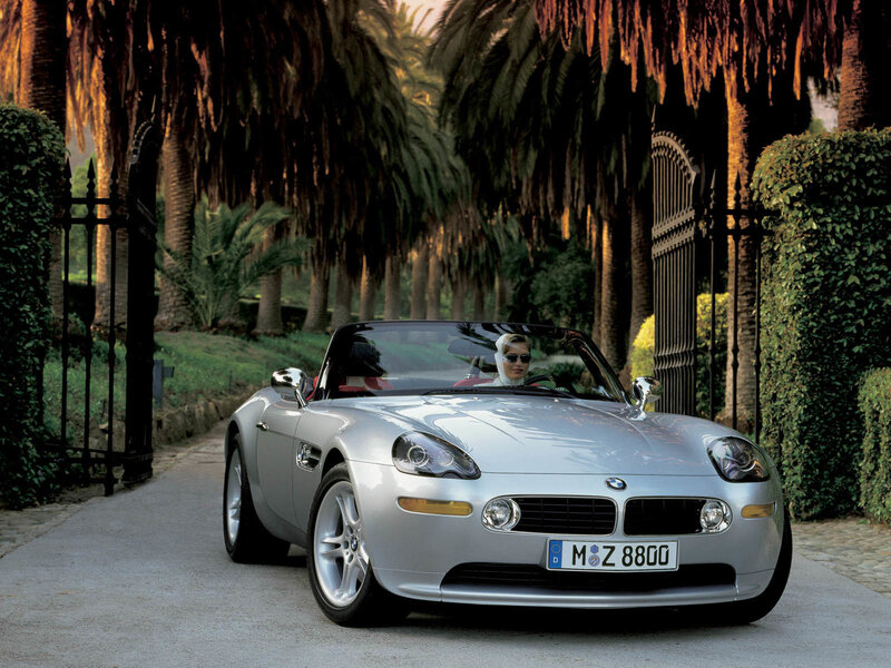 Silver BMW Z8 on a palm-lined road
