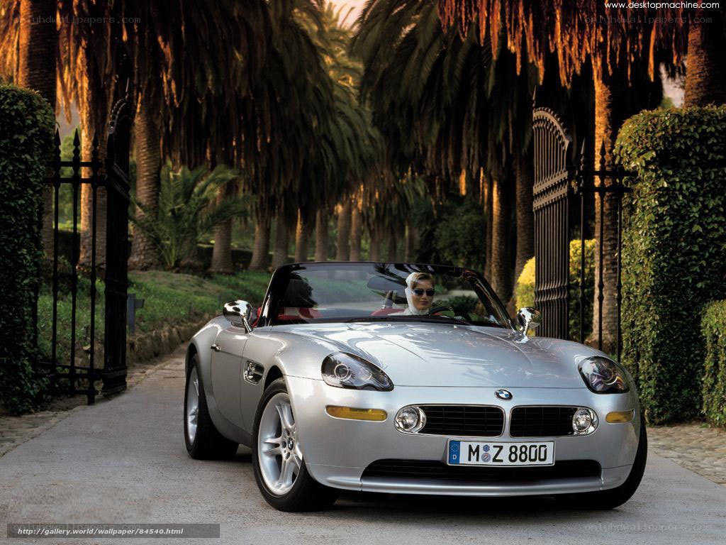 Silver BMW Z8 on a palm-lined road