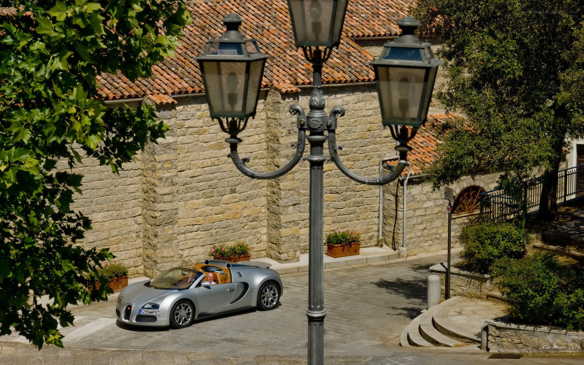 Silver Bugatti on a cobblestone street