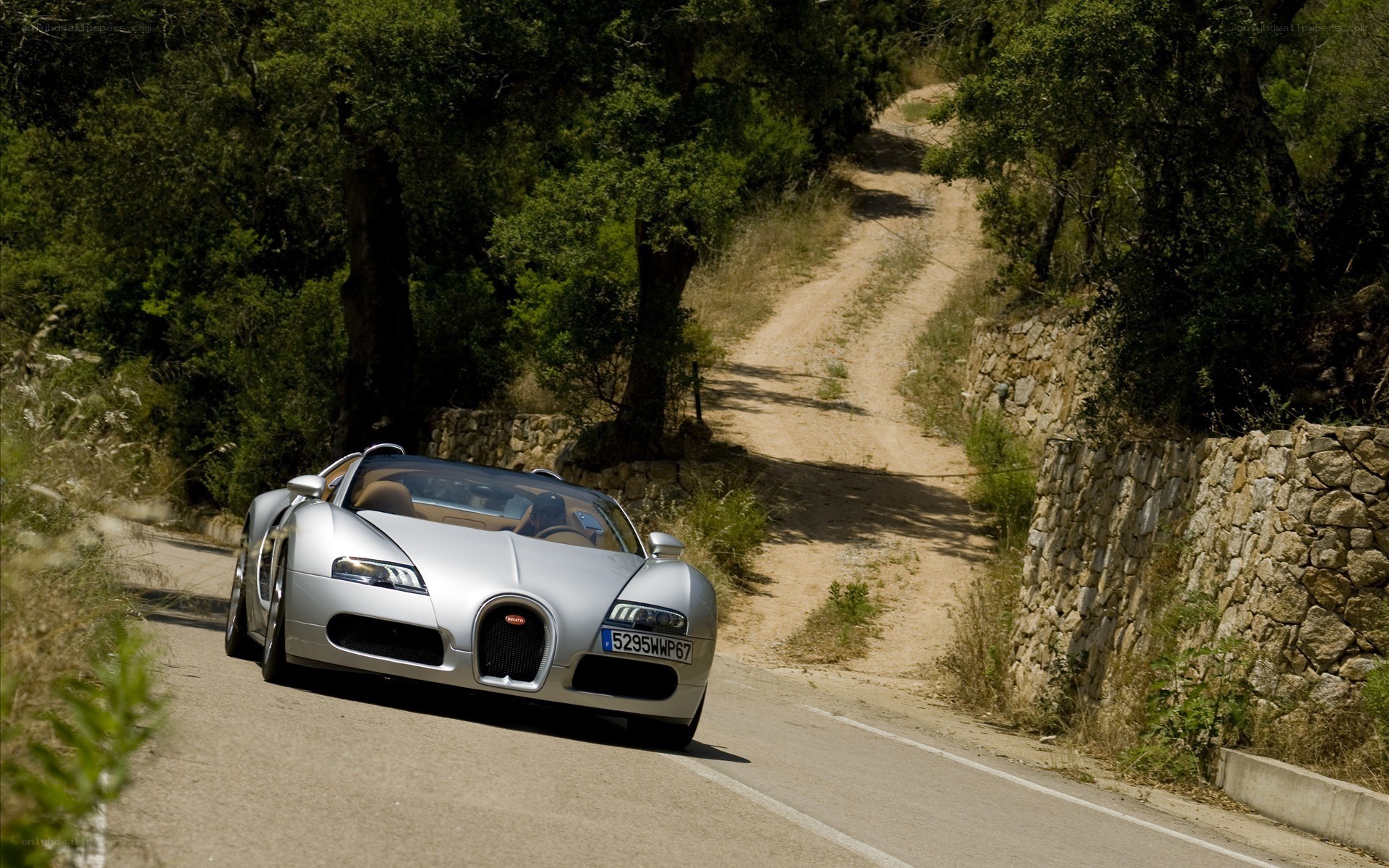 Silver Bugatti on a winding road