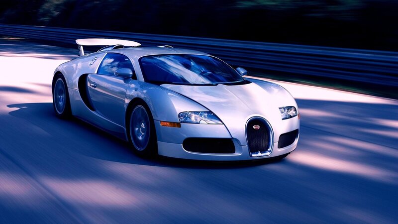 silver bugatti speeding on track