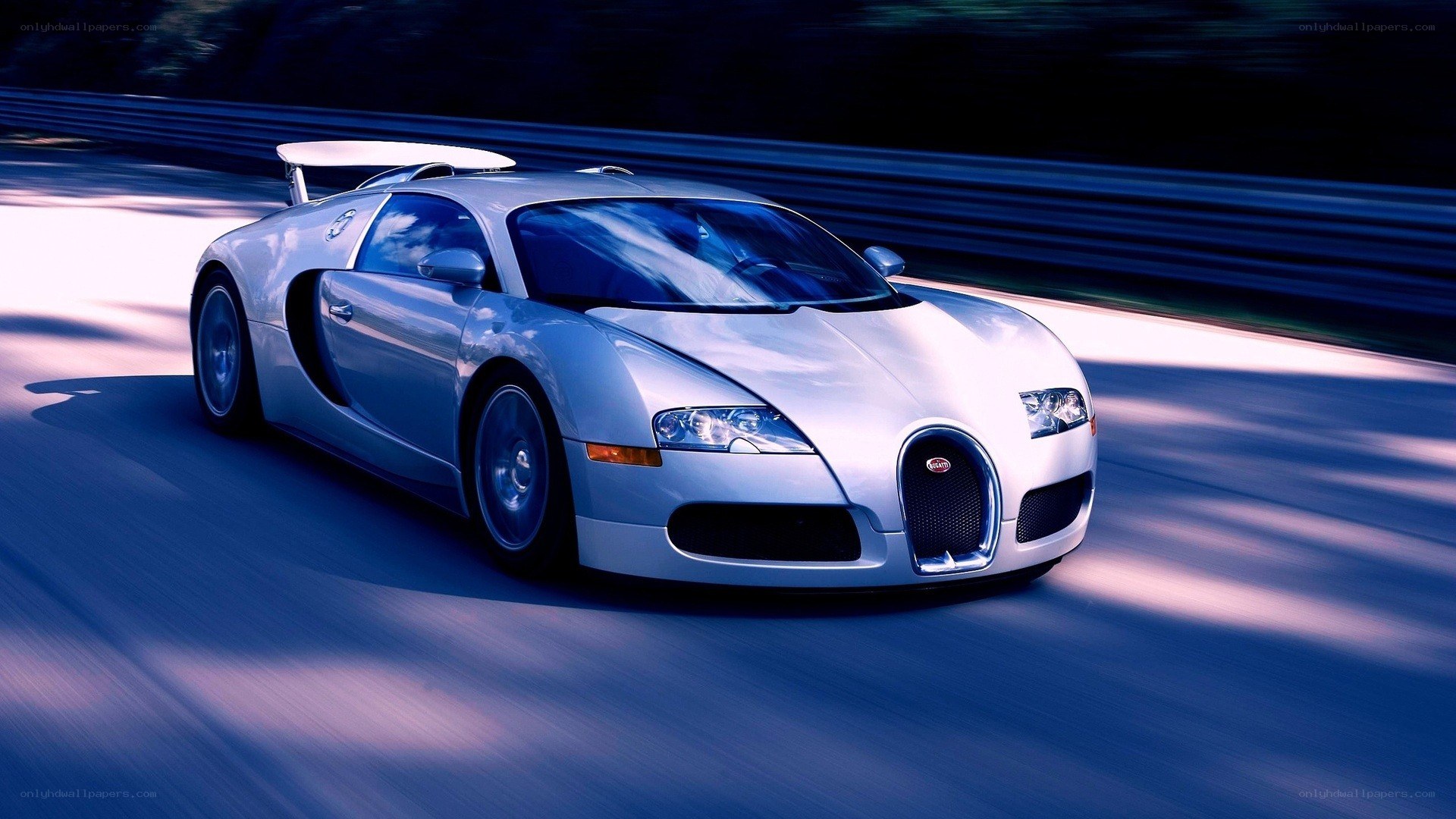 silver bugatti speeding on track