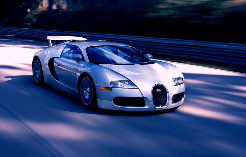silver bugatti speeding on track