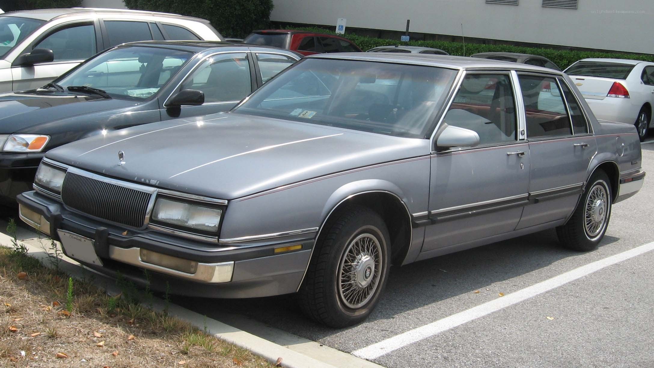 silver buick sedan in parking lot