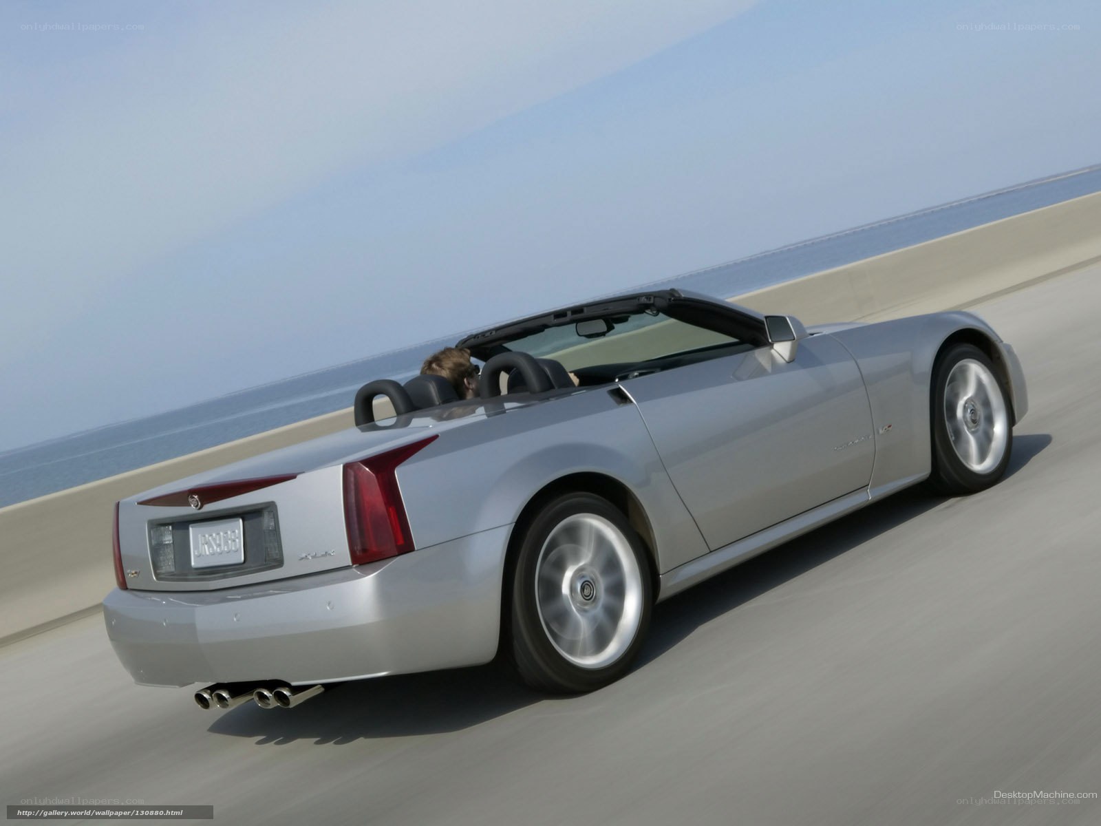 silver cadillac convertible driving