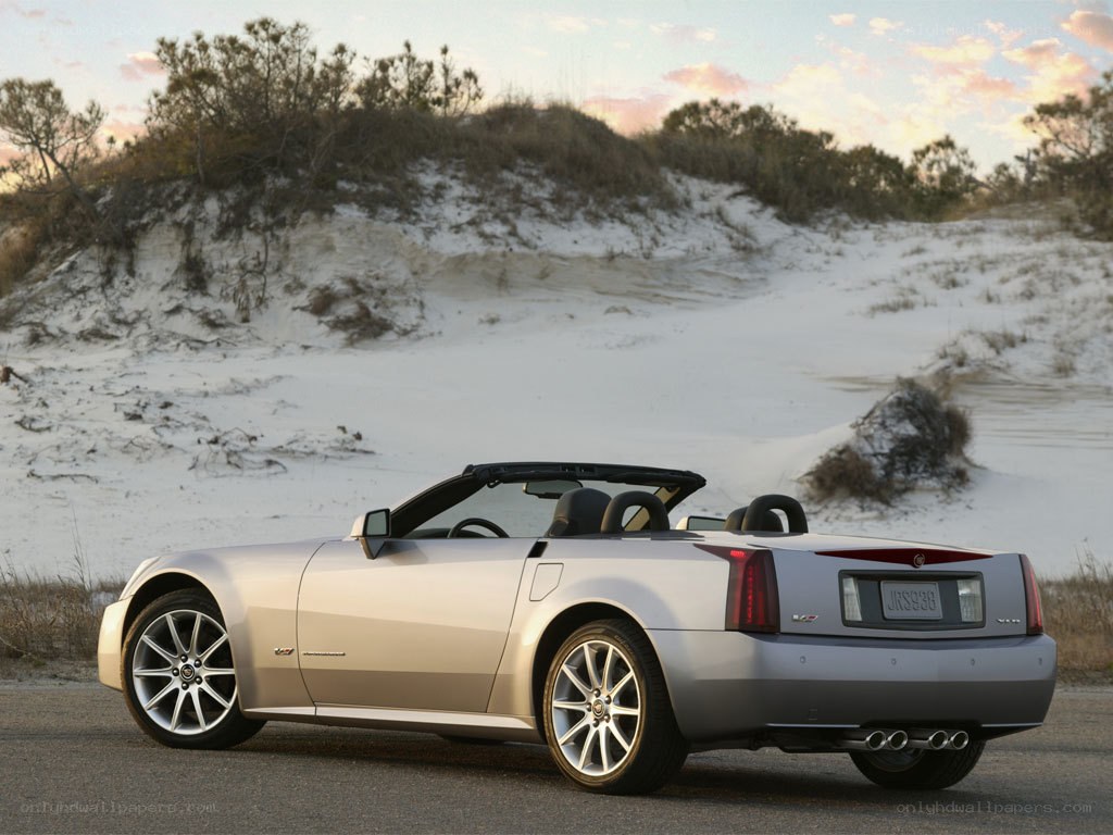 Silver Cadillac convertible on beach