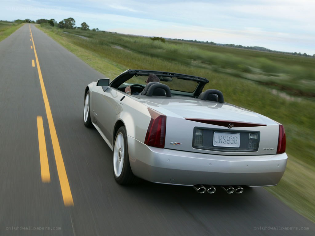 silver cadillac convertible on road