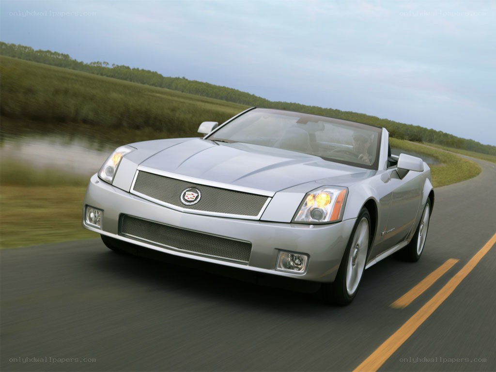 Silver Cadillac convertible on road