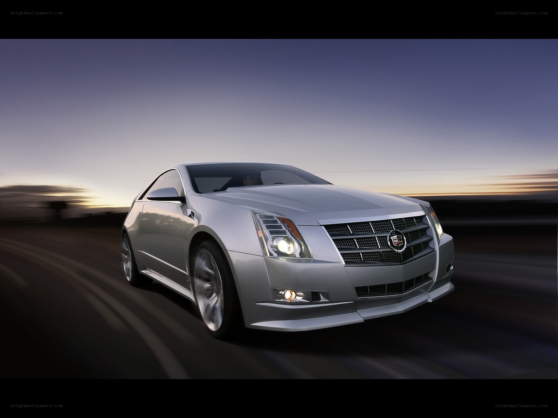 silver cadillac coupe in motion