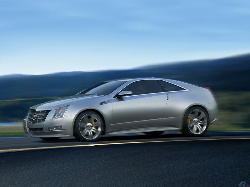 silver cadillac coupe in motion