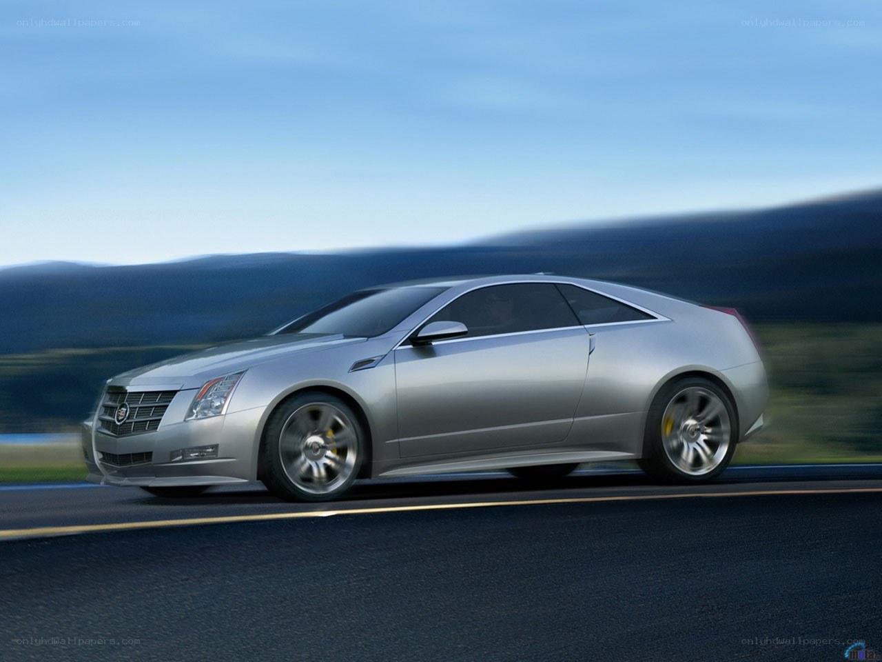 silver cadillac coupe in motion