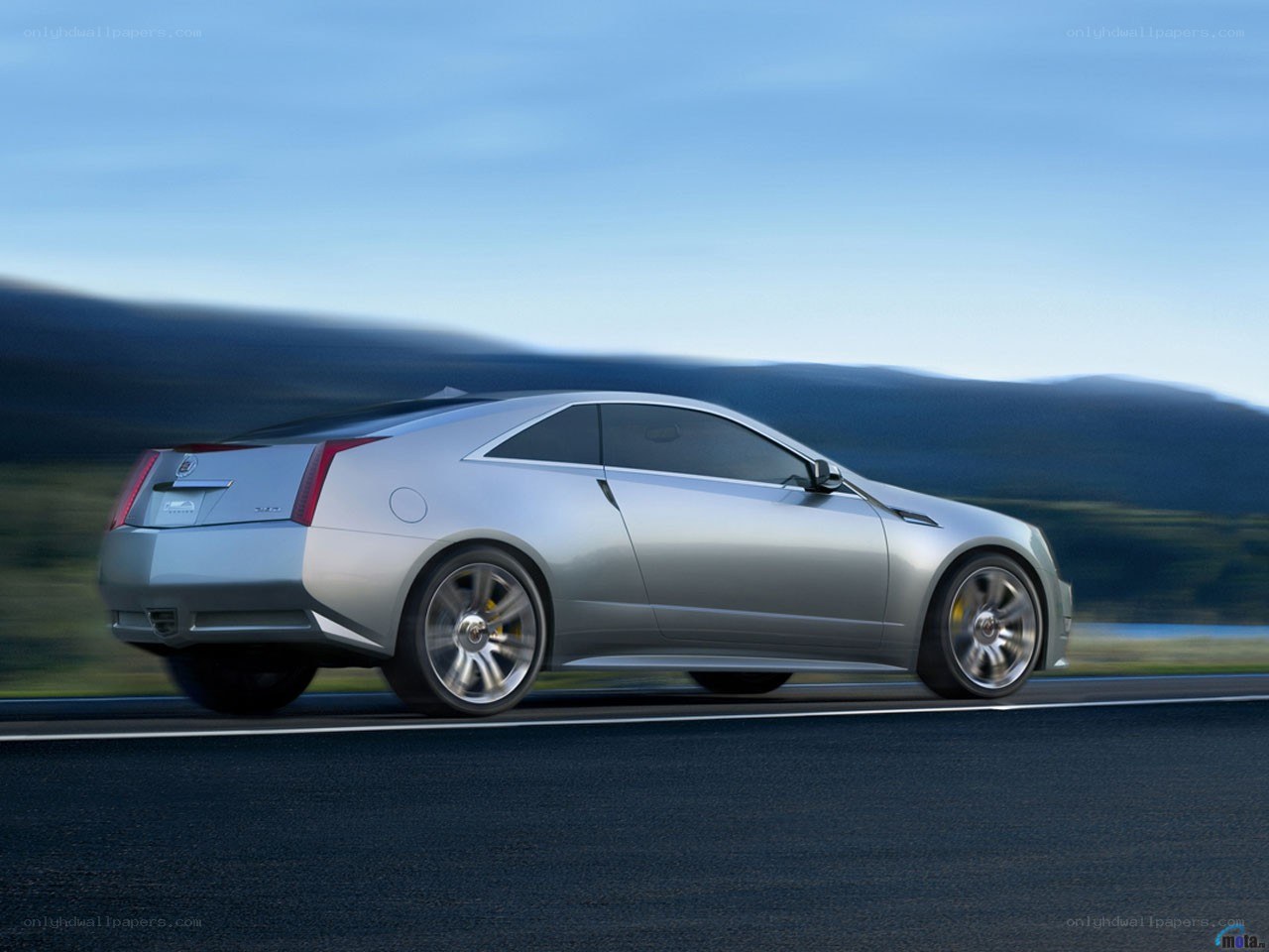 Silver Cadillac coupe in motion