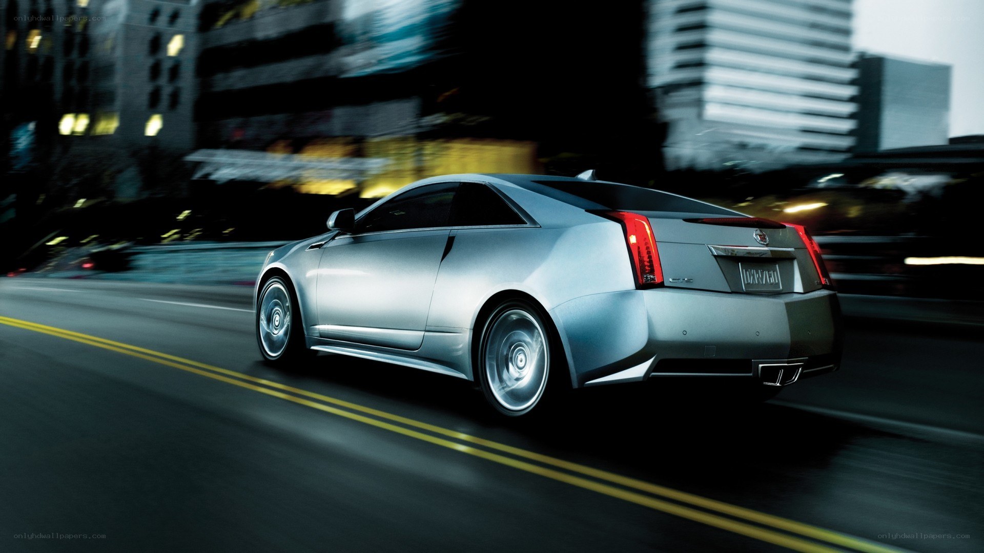 silver cadillac coupe in motion