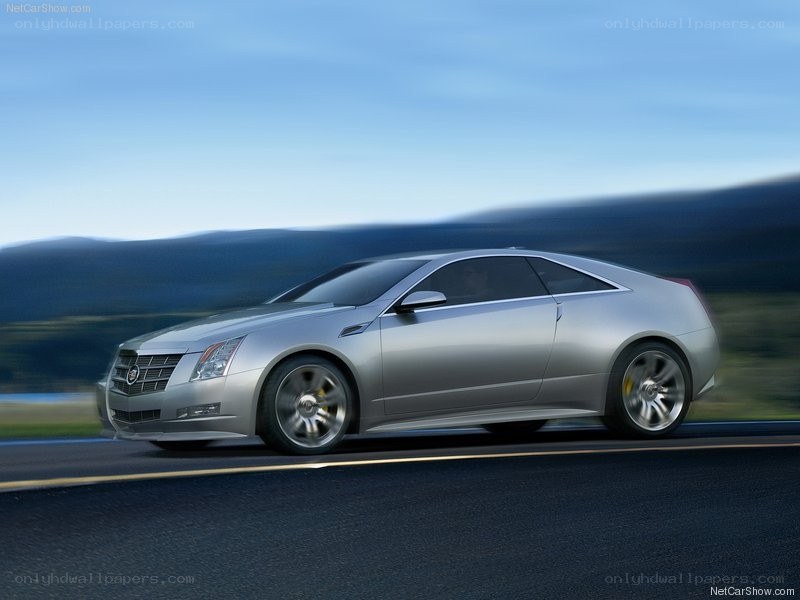 silver cadillac coupe in motion