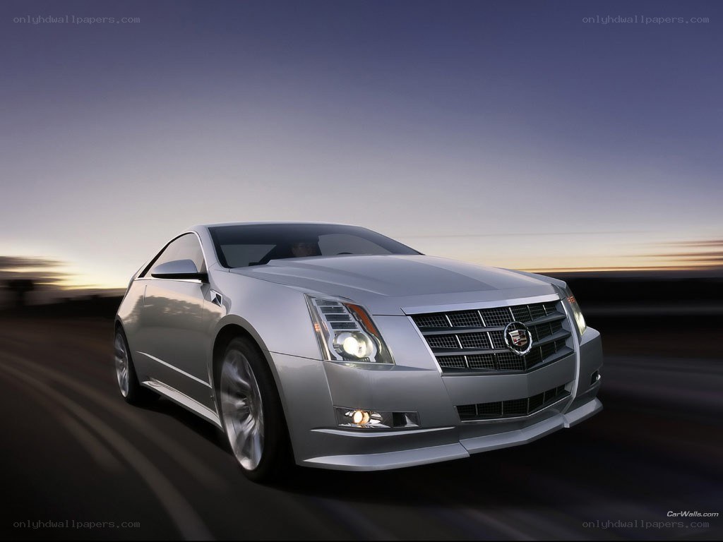 silver cadillac coupe in motion