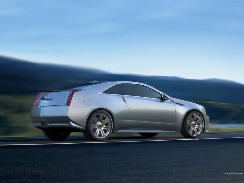 silver cadillac coupe in motion