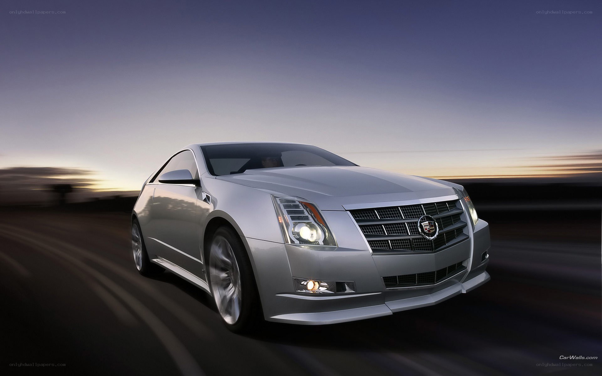 silver cadillac coupe in motion