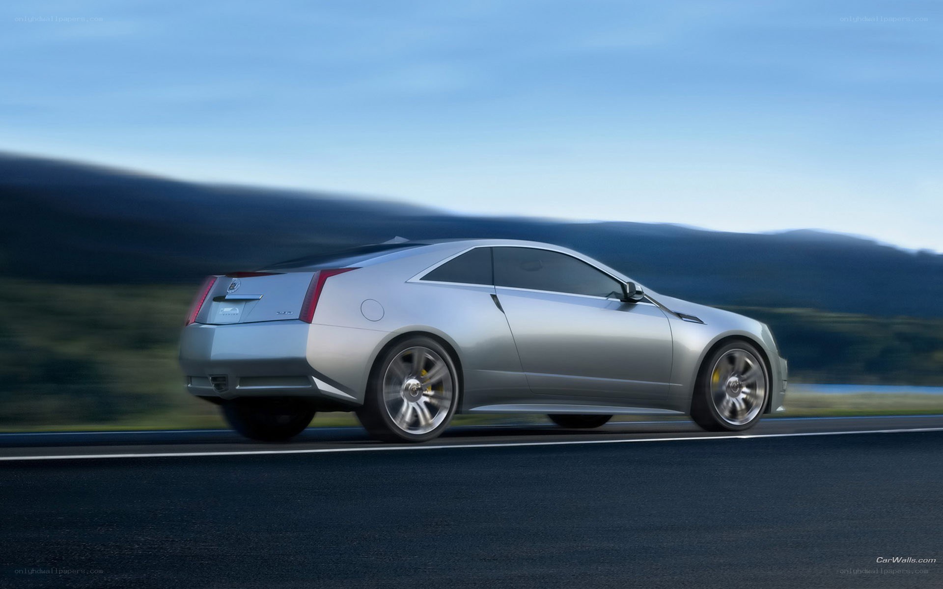 silver cadillac coupe in motion