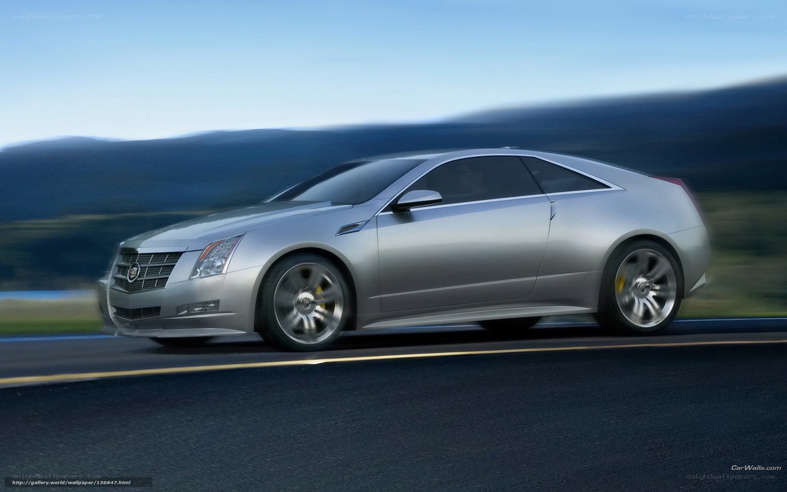 silver cadillac coupe in motion