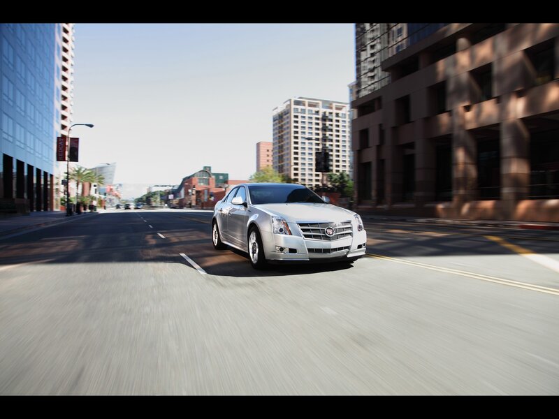 Silver Cadillac driving in city
