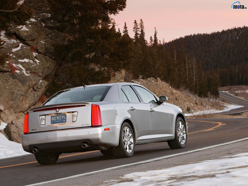 silver cadillac on mountain road