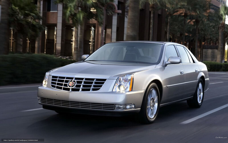 silver cadillac sedan on city street