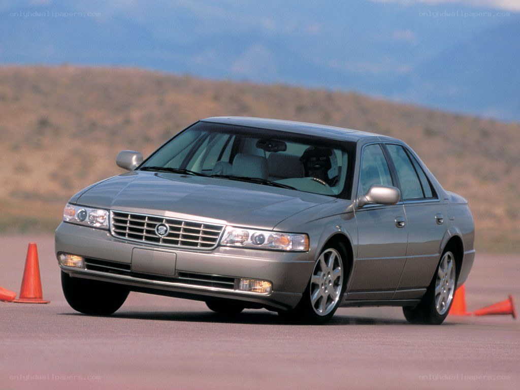 silver cadillac sedan on track