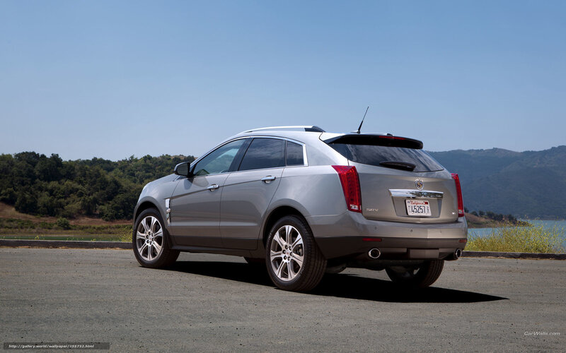 Silver Cadillac SRX parked by lake