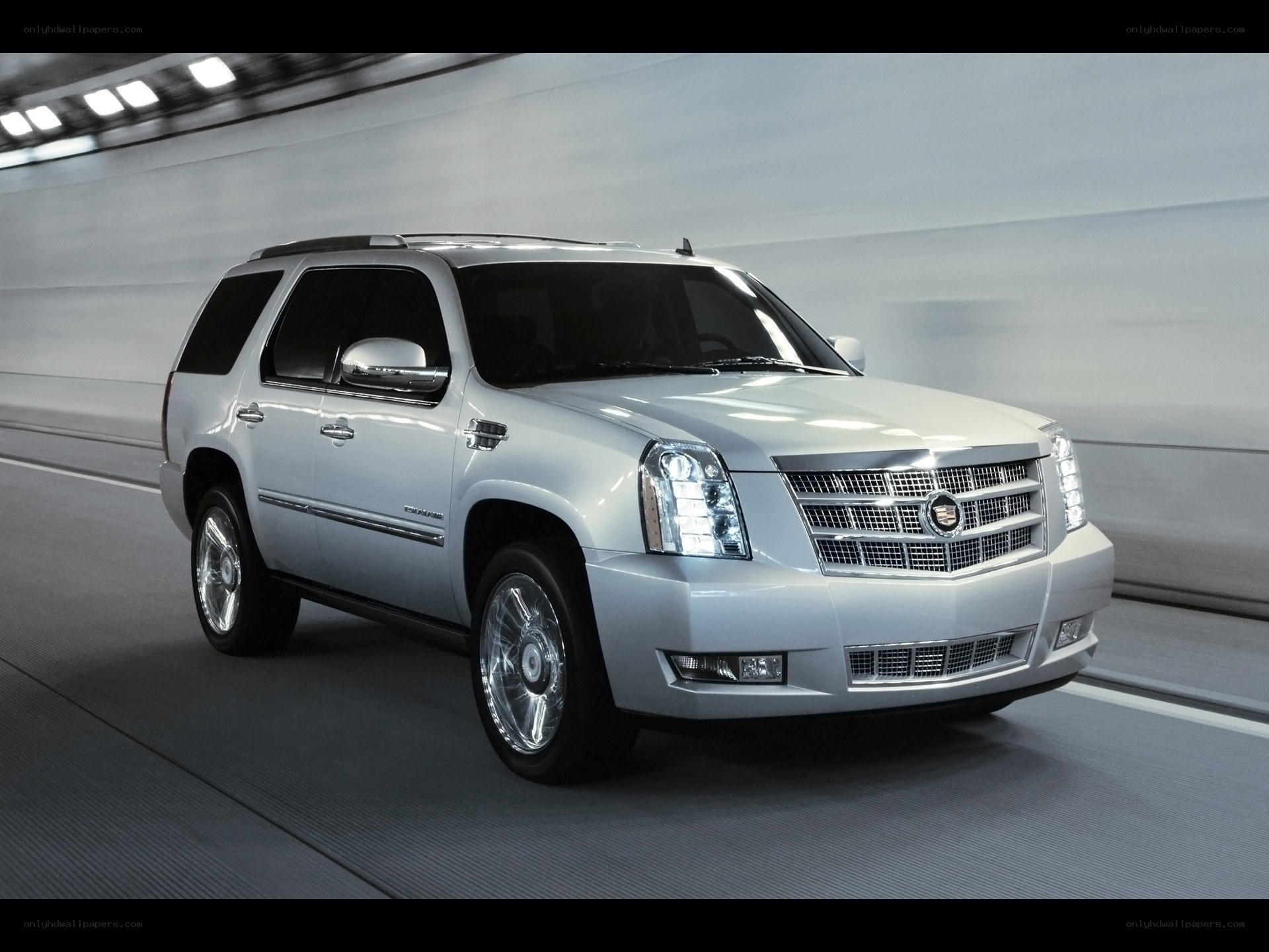silver cadillac suv in tunnel