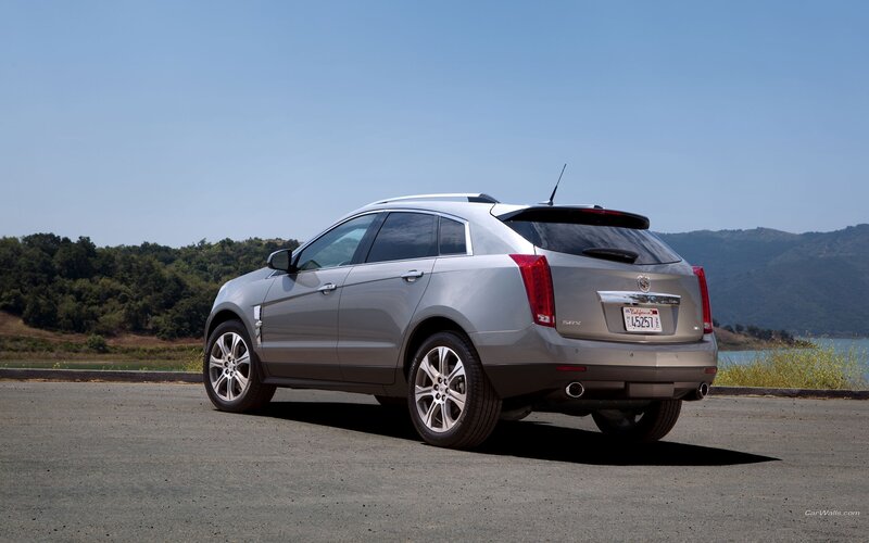 silver cadillac suv parked