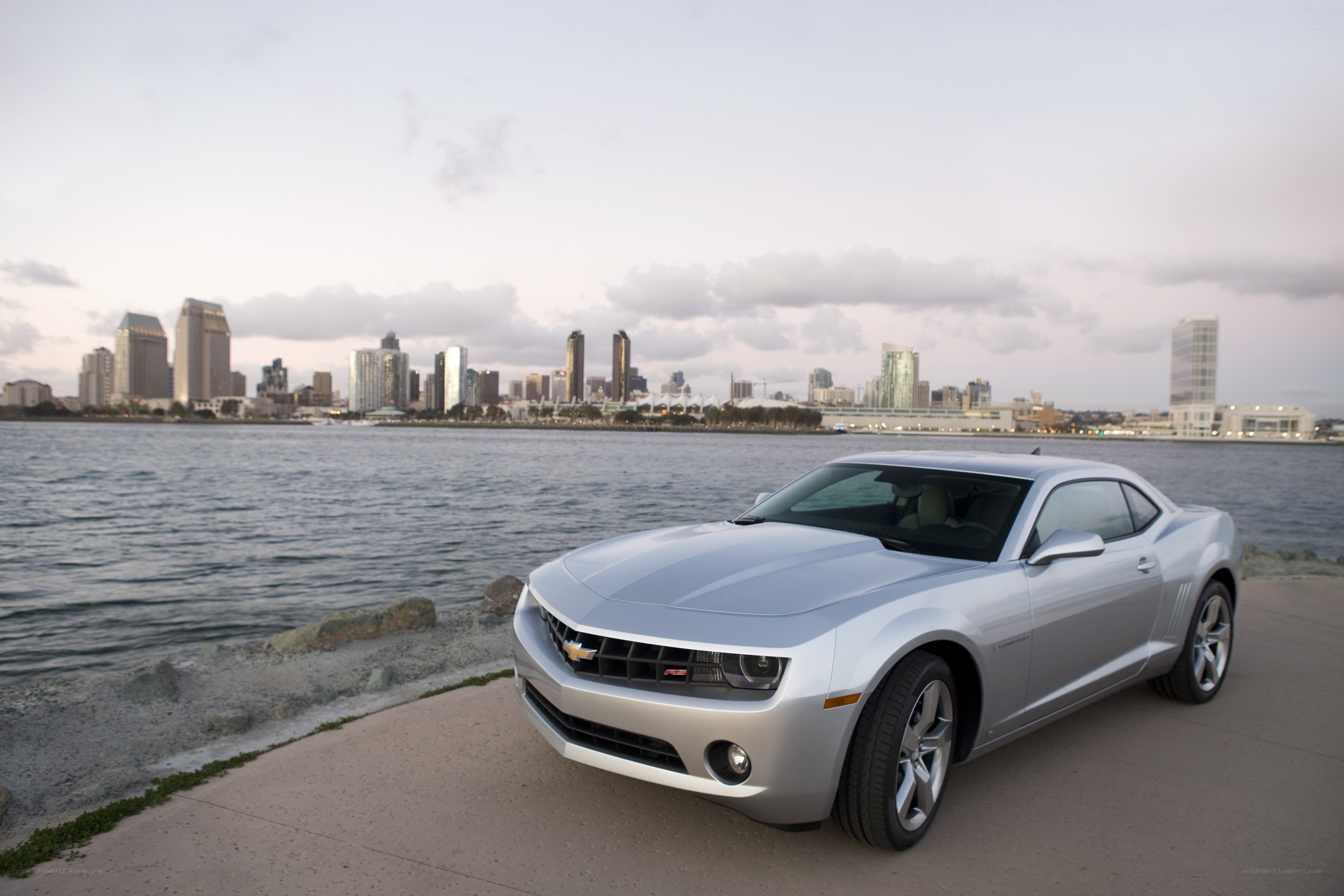 Silver Camaro by the waterfront