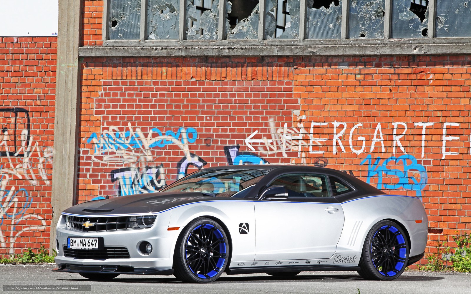 silver camaro on brick wall